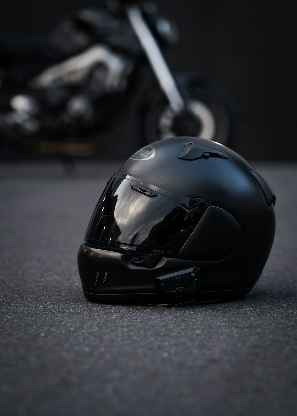 Two helmets and raincoats ready on a scooter seat